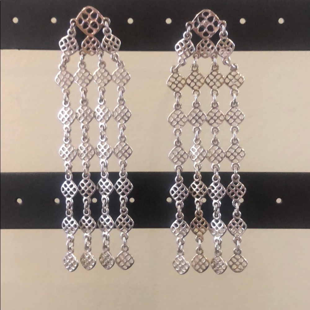 Decorative silver dangle earrings.